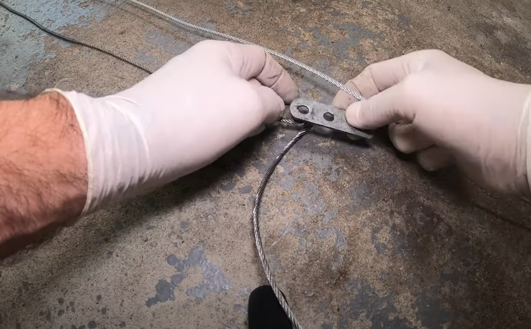 Technician performing garage door cable repair on a residential garage in Punta Gorda, FL.