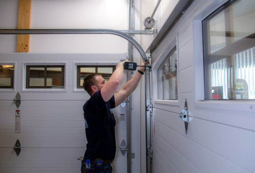 Technician performing garage door track repair in Punta Gorda, FL, ensuring smooth operation and alignment