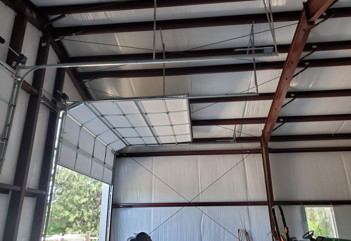 Technician repairing an overhead garage door in Punta Gorda, FL with professional tools, ensuring smooth operation and durability