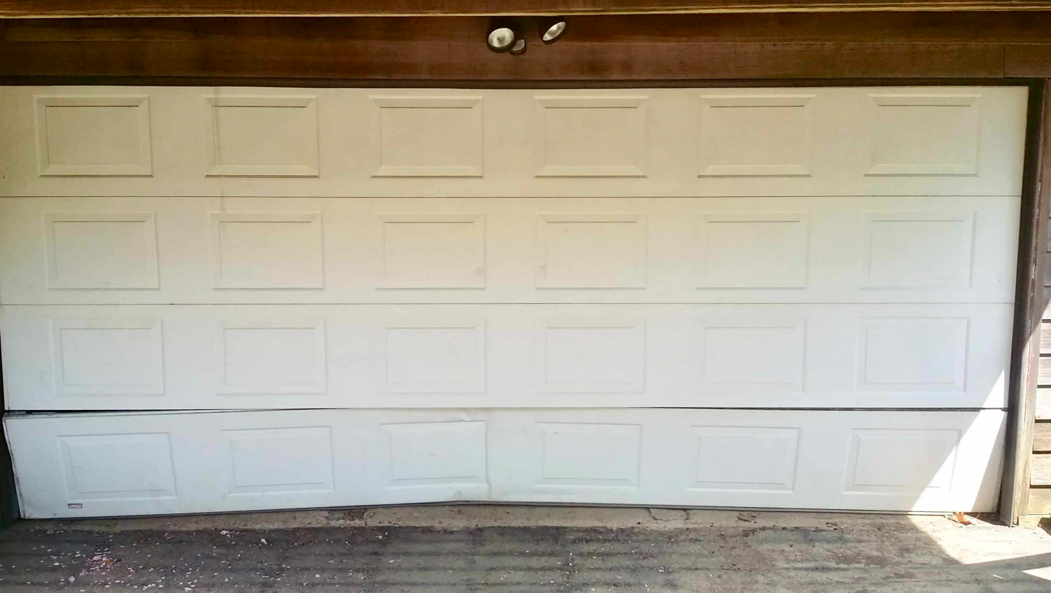 Technician performing a garage door section replacement in Punta Gorda, FL, showcasing professional tools and precise craftsmanship