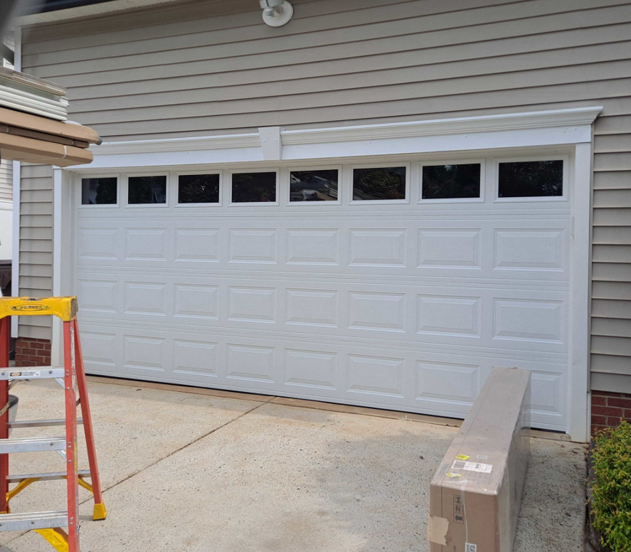 Technician performing a garage door section replacement in Punta Gorda, FL, using professional tools to restore functionality and appearance.