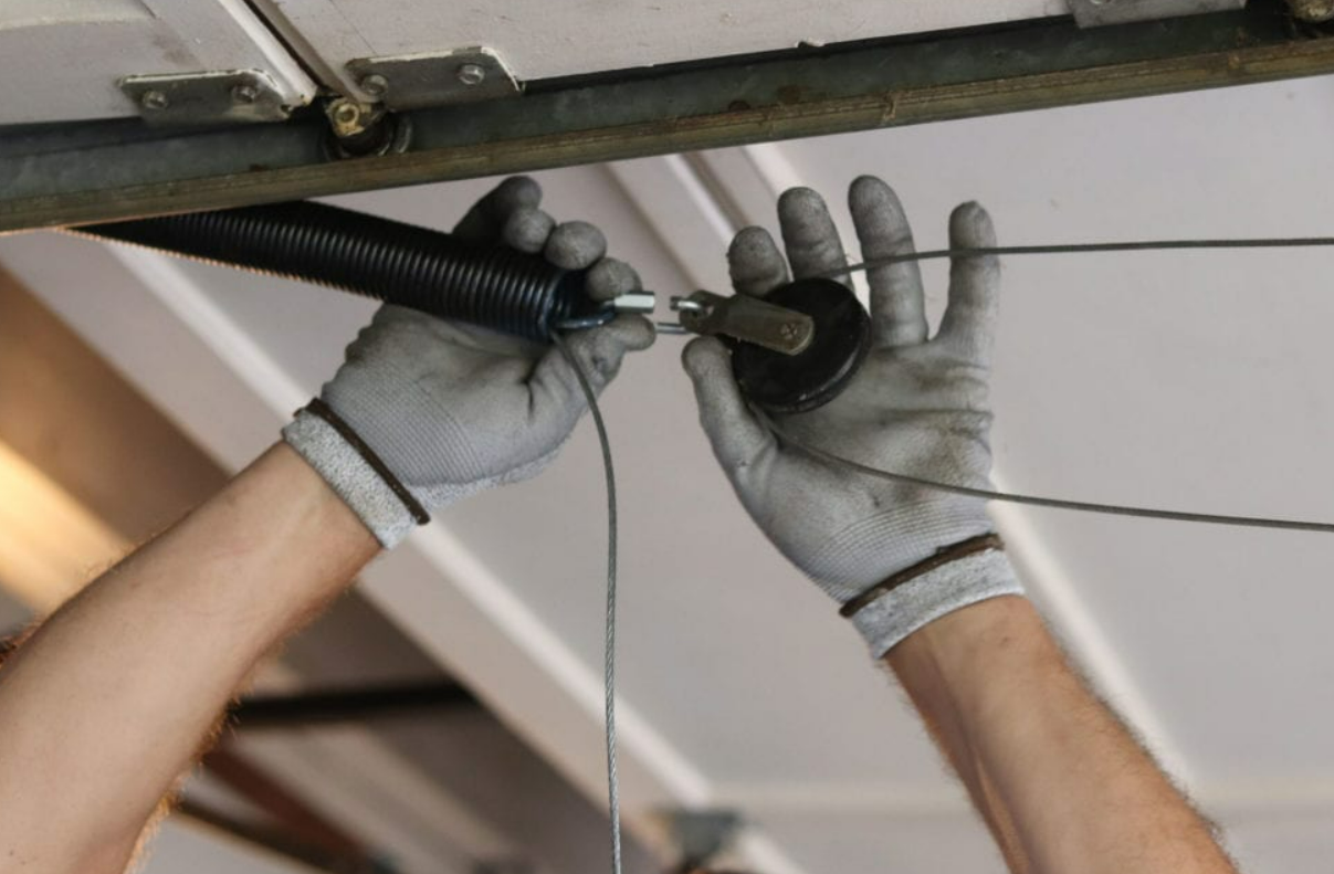 Technician performing garage door cable repair on a residential garage in Punta Gorda, FL.