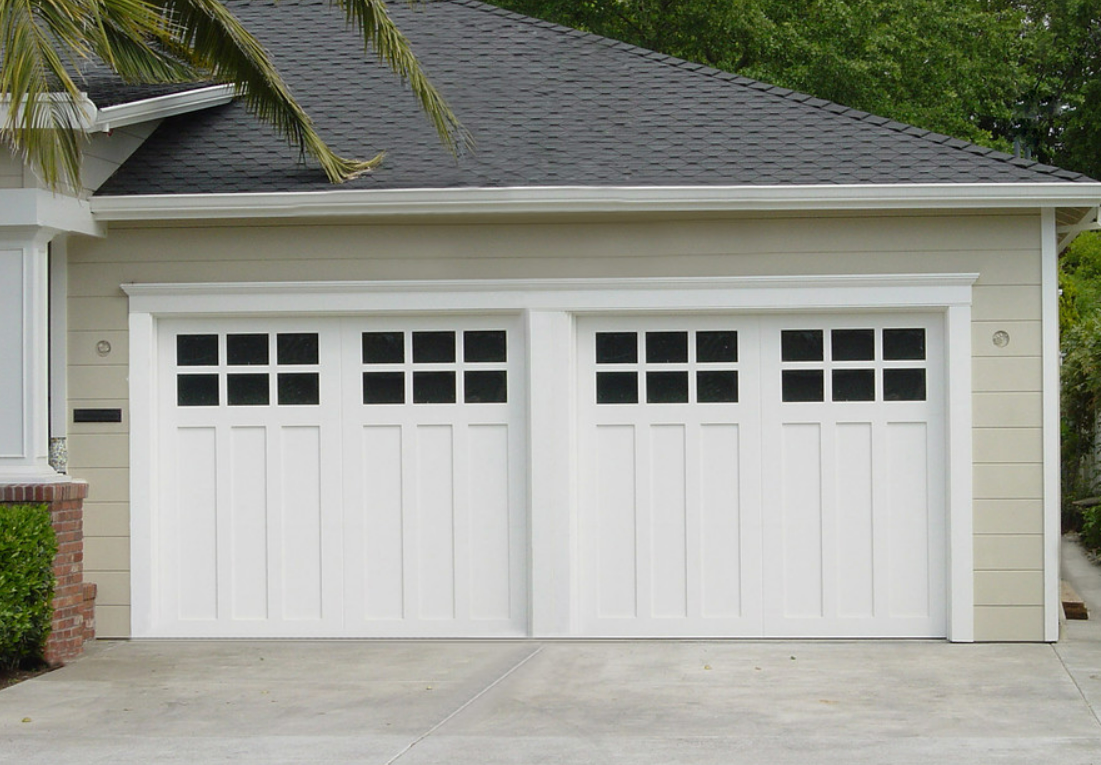 Technician providing same-day garage door repair service in Punta Gorda, FL, fixing a residential garage door.